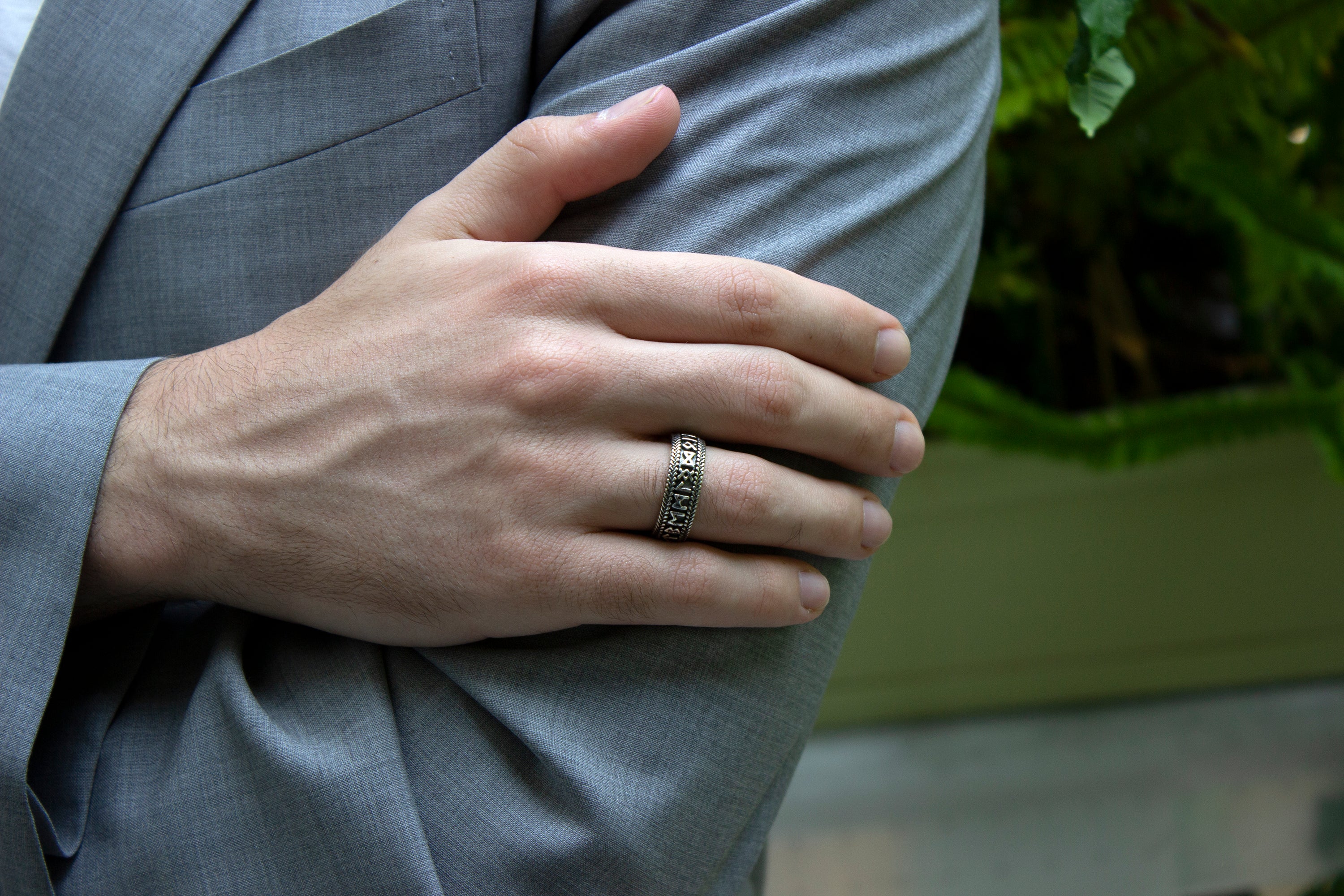 ring, ring on white background, mens rings, women's rings, yellow gold plated ring, runic ring, viking ring, custom ring, sterling silver ring, silver ring, runes ring, personalized engraving, engraved ring, man wearing a ring, mens ring, hand model