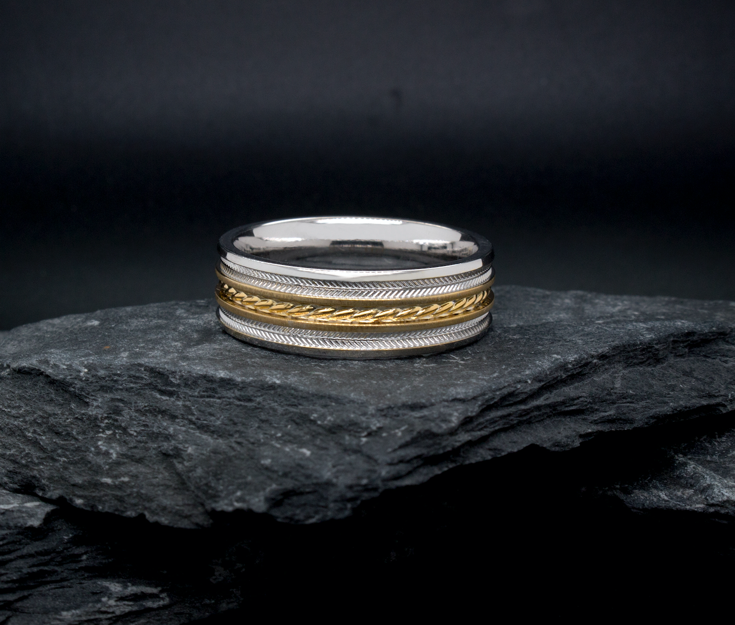 ring, ring on black background, solid gold ring, white gold ring, yellow gold ring, textured ring, engraved ring, two-toned ring, wedding band, flat shaped ring, mens wedding band, womens wedding band, unisex ring
